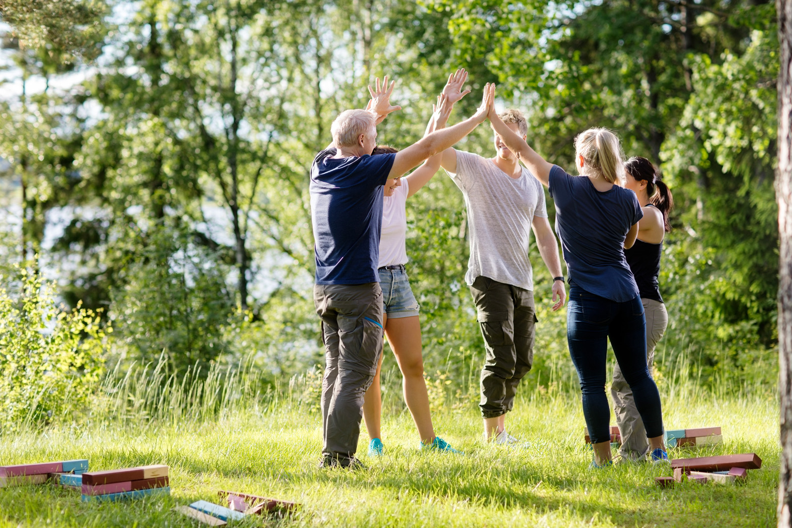 Coworkers Giving High-Five After Playing With Building Blocks On